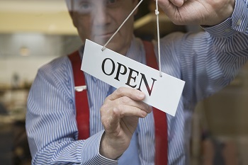 man flipping over and open sign